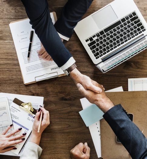 Business people shaking hands together